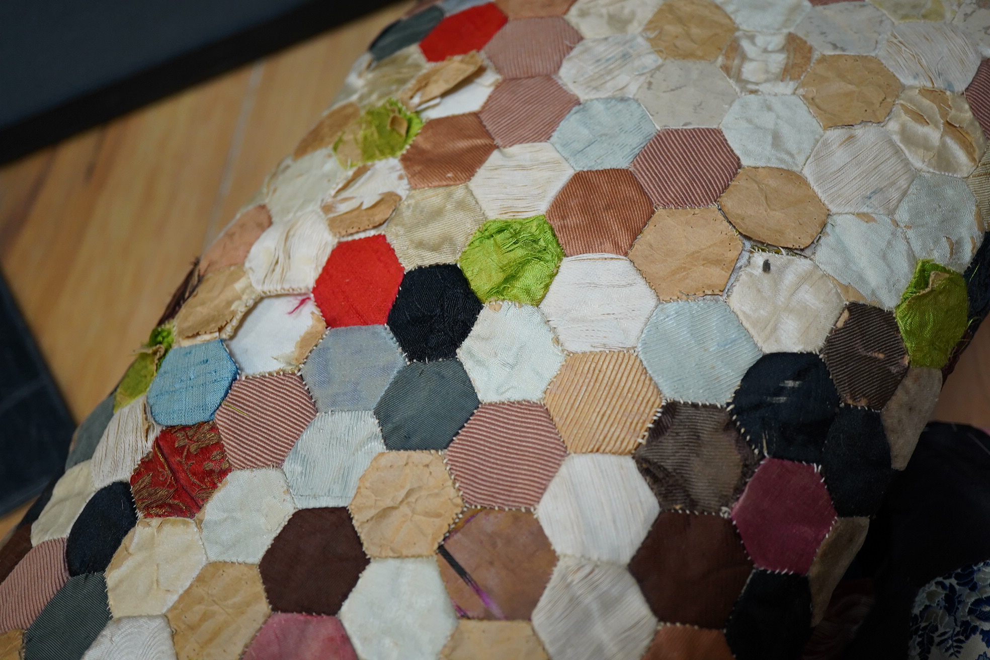 Three various sized 19th century patchwork panels and two patch worked cushions, for using as restoration fabric for larger damaged quilts.